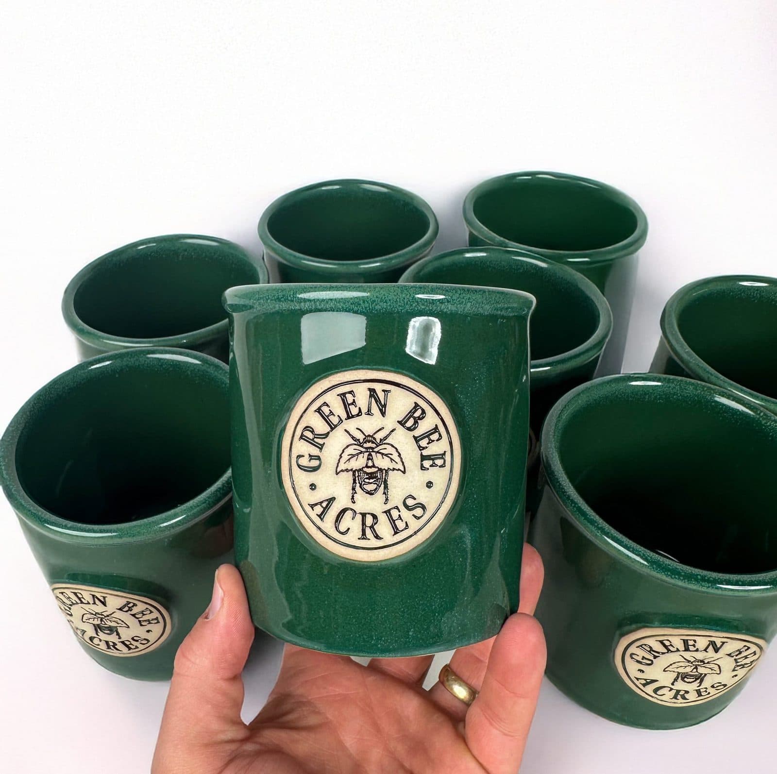 Green Bee Acres handful of branded ceramic mugs