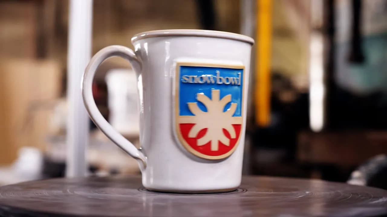 Custom logo mugs turning on the wheel in the JJ Potts studio